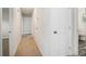 Hallway featuring neutral carpeting, storage shelves, and an adjacent full bathroom at 4601 Lindsey Dr, Powder Springs, GA 30127