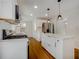 Updated kitchen featuring stainless steel appliances, island, and wood flooring at 4601 Lindsey Dr, Powder Springs, GA 30127