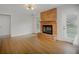 Living room featuring a brick fireplace, hardwood floors, and natural light at 4601 Lindsey Dr, Powder Springs, GA 30127