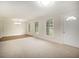 Spacious living room with abundant natural light and neutral carpet and wood floors at 4601 Lindsey Dr, Powder Springs, GA 30127