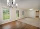 Large living room with big windows and a combination of carpet and wood flooring at 4601 Lindsey Dr, Powder Springs, GA 30127
