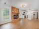 Open-concept living area featuring a brick fireplace and modern kitchen at 4601 Lindsey Dr, Powder Springs, GA 30127
