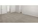 Spacious bedroom with a plush carpet and entry door at 104 Crooked Lake Park, Villa Rica, GA 30180