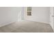 Bedroom featuring gray carpet, a window and door in a neutral color scheme at 104 Crooked Lake Park, Villa Rica, GA 30180