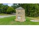 Community entrance monument with lush landscaping and a stone-clad monument sign at 104 Crooked Lake Park, Villa Rica, GA 30180