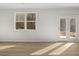 Living room with hardwood floors, large windows, and lots of light at 104 Crooked Lake Park, Villa Rica, GA 30180