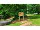 A Little Vine Vineyards & Winery sign surrounded by lush greenery at 104 Crooked Lake Park, Villa Rica, GA 30180