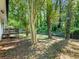 Lush backyard featuring a wooden deck, mature trees, and a well-maintained lawn at 4059 Big Valley Trl, Stone Mountain, GA 30083