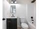 Well-lit bathroom featuring a modern vanity, black fixtures, and a bathtub with white tile surround at 4059 Big Valley Trl, Stone Mountain, GA 30083
