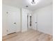 A cozy bedroom with wood-look floors, showcasing a glimpse into the adjacent bathroom and closet space at 4059 Big Valley Trl, Stone Mountain, GA 30083