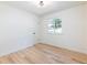 A bright bedroom featuring modern flooring and a window offering serene views of the surrounding greenery at 4059 Big Valley Trl, Stone Mountain, GA 30083