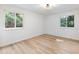A naturally lit bedroom with wood-look flooring is bathed in sunlight from its well placed windows at 4059 Big Valley Trl, Stone Mountain, GA 30083