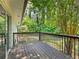 Spacious wooden deck, offering peaceful views of the surrounding lush greenery and mature trees at 4059 Big Valley Trl, Stone Mountain, GA 30083