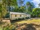 Charming home with well-maintained landscaping, a neatly trimmed lawn, and plenty of natural shade at 4059 Big Valley Trl, Stone Mountain, GA 30083