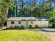 Charming, remodeled single-story home with beautiful lawn, fresh paint, updated landscape, and driveway at 4059 Big Valley Trl, Stone Mountain, GA 30083