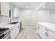 Modern kitchen with stainless steel sink, updated appliances, white cabinetry, and tile backsplash at 4059 Big Valley Trl, Stone Mountain, GA 30083