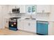 Bright kitchen featuring stainless steel appliances, white cabinets, and neutral flooring at 4059 Big Valley Trl, Stone Mountain, GA 30083