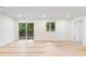 Bright living room with sliding door access to balcony and view of surrounding trees at 4059 Big Valley Trl, Stone Mountain, GA 30083