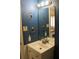 Bathroom with tiled walls, vanity, and a large mirror reflecting the bedroom at 4814 Delgado Dr Sw, Lilburn, GA 30047