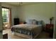 Bedroom with wood floors, two dressers, and a window overlooking the front yard at 4814 Delgado Dr Sw, Lilburn, GA 30047