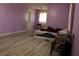 Bedroom with modern flooring and purple painted walls at 4814 Delgado Dr Sw, Lilburn, GA 30047