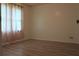 Bright bedroom featuring light-colored wood floors and a window with curtains at 4814 Delgado Dr Sw, Lilburn, GA 30047