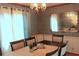 Traditional dining room with wallpaper, chandelier, mirror, and seating for six at 4814 Delgado Dr Sw, Lilburn, GA 30047