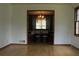 Open dining room with wood floors, chandelier, and view into another room at 4814 Delgado Dr Sw, Lilburn, GA 30047