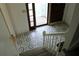 View from the top of the stairs down into the entryway with decorative tile at 4814 Delgado Dr Sw, Lilburn, GA 30047