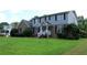 Attractive two-story home with a green lawn and tidy landscaping surrounding the front entrance at 4814 Delgado Dr Sw, Lilburn, GA 30047