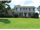 Lovely two-story home with a brick and light blue facade, complemented by a lush green lawn at 4814 Delgado Dr Sw, Lilburn, GA 30047