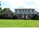 Charming two-story home featuring a well-manicured lawn and inviting front porch with beautiful shrubbery at 4814 Delgado Dr Sw, Lilburn, GA 30047