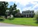Charming two-story home with a well-maintained lawn and mature trees surrounding the property at 4814 Delgado Dr Sw, Lilburn, GA 30047