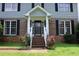 Inviting front entrance featuring brick steps, white railings, and lovely flower bushes at 4814 Delgado Dr Sw, Lilburn, GA 30047