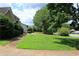 Expansive green lawn with mature trees in a suburban neighborhood at 4814 Delgado Dr Sw, Lilburn, GA 30047