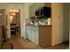 Galley kitchen features a microwave, mosaic backsplash, and view into the dining room at 4814 Delgado Dr Sw, Lilburn, GA 30047