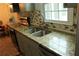 Kitchen counter with double sink, granite countertops, and mosaic tile backsplash at 4814 Delgado Dr Sw, Lilburn, GA 30047