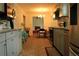 Open kitchen with ample cabinets and countertops that leads into a Gathering room at 4814 Delgado Dr Sw, Lilburn, GA 30047