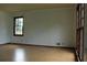 Bright living room with hardwood floors and natural light from the large windows at 4814 Delgado Dr Sw, Lilburn, GA 30047