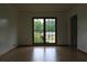 Living room with hardwood floors and large window overlooking the front yard at 4814 Delgado Dr Sw, Lilburn, GA 30047