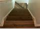 Stairs with wooden steps and white trim at 4814 Delgado Dr Sw, Lilburn, GA 30047