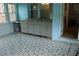 Cozy sunroom with accent-painted brick, unique tile flooring, and a utility sink at 4814 Delgado Dr Sw, Lilburn, GA 30047
