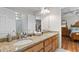 Bathroom with granite countertop on vanity, a shower with glass door, and access to the main bedroom at 401 Riverwalk, Mcdonough, GA 30252