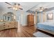 Spacious main bedroom with wood floors, tray ceiling, and ensuite bathroom at 401 Riverwalk, Mcdonough, GA 30252