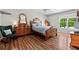 Spacious bedroom features wood floors, a ceiling fan and large windows overlooking a leafy green backyard at 401 Riverwalk, Mcdonough, GA 30252