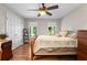 Bedroom with wood floor, neutral colored walls, and backyard view from one of two windows at 401 Riverwalk, Mcdonough, GA 30252