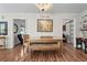 Bright dining room with wood floors, chandelier, and natural light at 401 Riverwalk, Mcdonough, GA 30252