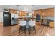Modern kitchen boasting stainless steel appliances, stylish cabinetry, granite countertops, and eat-in island at 401 Riverwalk, Mcdonough, GA 30252