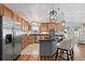 Bright and open kitchen with wood cabinetry, stainless steel appliances, granite countertops, and eat-in island at 401 Riverwalk, Mcdonough, GA 30252
