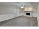 The finished basement boasts new floors, wainscotting, and a charming painted brick fireplace with a door to the backyard at 650 Lake Forest Ct, Roswell, GA 30076